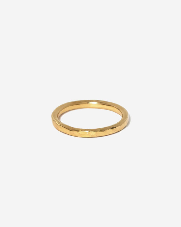 A slim gold stacking ring with hammered texture for light reflecting qualities. the ring is gold vermeil and 100% handmade