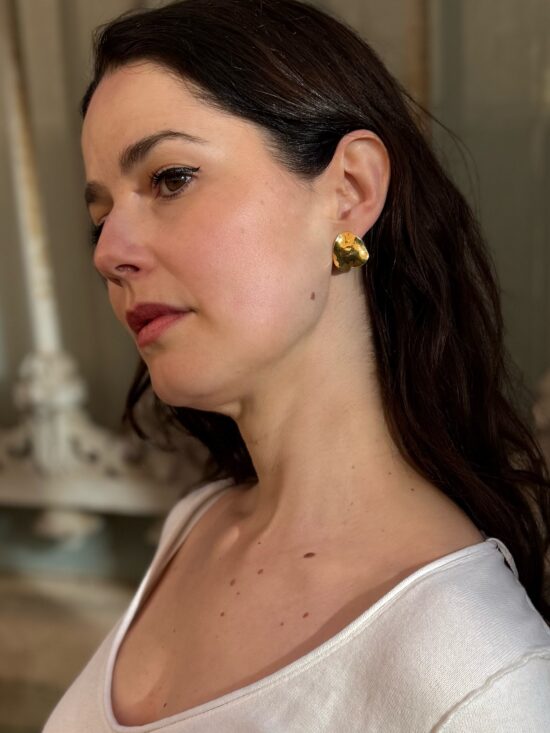 Woman wearing chunky gold vermeil Tide statement earrings